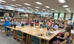 First 10 Loudoun County members meeting around a table in a library.